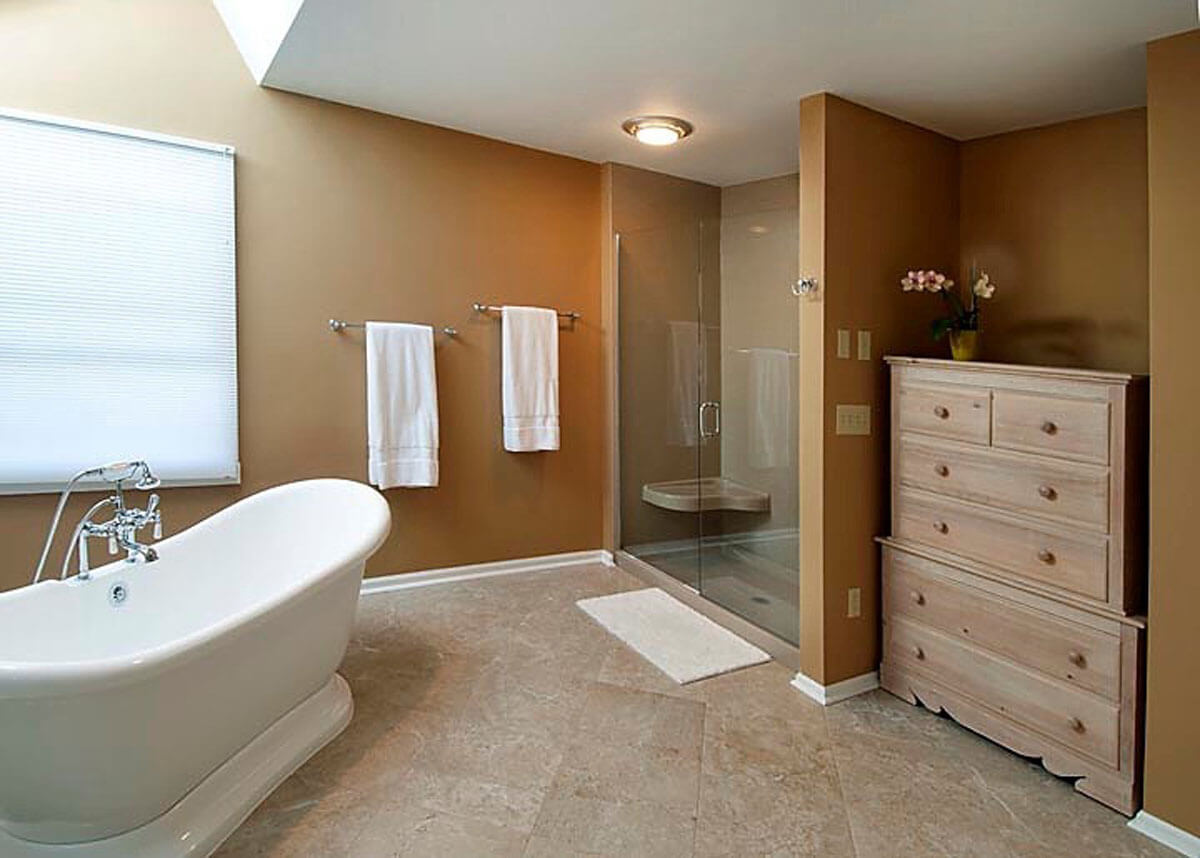 Shower and Separate Tub In A Sky lit Bathroom